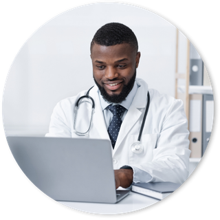 Family doctor looking at his laptop